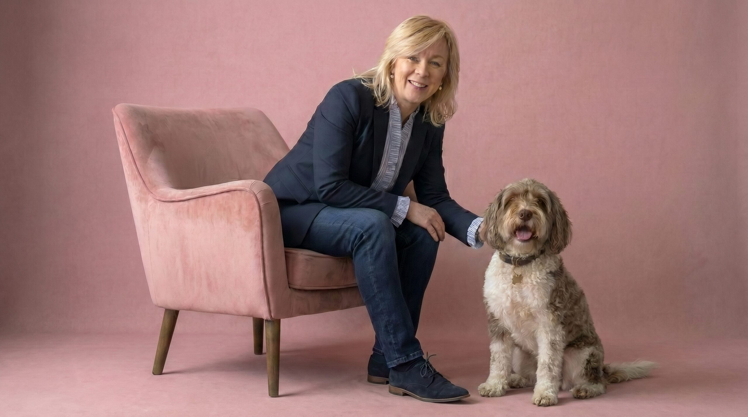 Kineton property expert Sara Jordan sat with her dog Milly on a Etta James property pint background